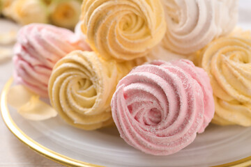 Yellow and pink delicious marshmallows on plate, closeup