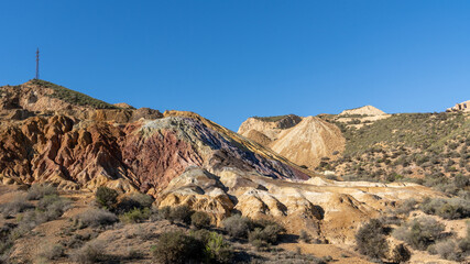 Fototapeta na wymiar landscape view of colorful earthen hillside in an abandonend mine