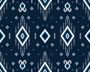 Obraz premium Ethnic blue ikat tribal seamless pattern. geometric folklore ornament. design for background,wallpaper,fabric,carpet,clothing,wrapping,batik. vector illustration in embroidery style.