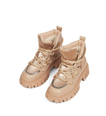 Woman's beige leather warm winter boots over white background