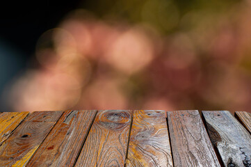 Old teak wood empty table in front of pink bokeh background for display of product