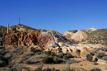 landscape view of colorful earthen hillside in an abandonend mine