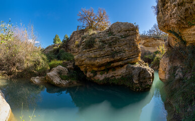 the Salto del Usero nature reserve with eroded sandstone cliffs and colorful pools of water