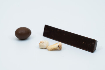 Human tooth caries with chocolate (sweets) on white background