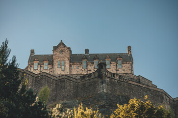 Fototapeta na wymiar Edinburgh Castle, a royal castle occupying a commanding position atop a volcanic crag with cliffs on three sides and the fourth side facing the capital city of Edinburgh