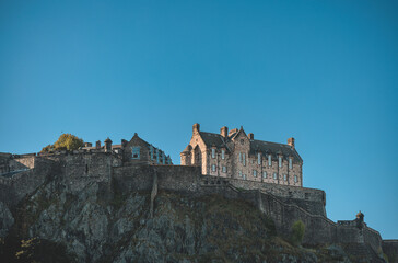 Edinburgh Castle, a royal castle occupying a commanding position atop a volcanic crag with cliffs...