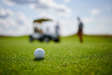 Golf ball on the background of a golf cart
