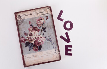 a notebook with roses on a light background. I love the inscription on a light background. inscription and notepad