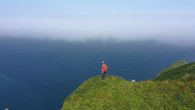 Traveler Standing on Edge of Shikotan Island and Looking on Pacific Ocean, Lesser Kuril Chain, Russia. Drone Shot.