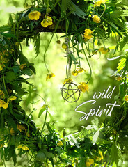 flowers wreath and pentagram amulet in forest, green natural background. Wild Spirit. wiccan magic, Mysticism, occultism concept. witchcraft esoteric ritual for spring season