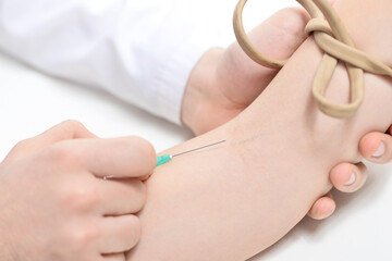 Hands of doctor inject a patient into vein. How to give an intravenous injection concept.  Close-up