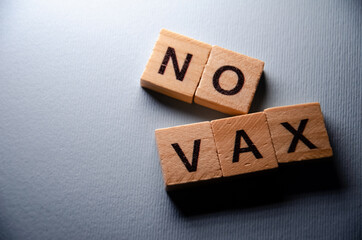 No vax concept. Anti-vaccination from coronavirus. Inscription No vax background. Selective focus on Lettering No vax with. Banner on blue background.