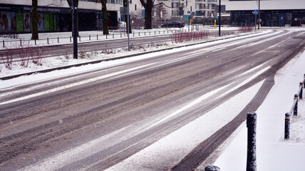 Slippery snowy city road during winter. Difficult weather conditions. Dangerous traffic. © Grand Warszawski
