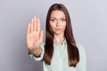 Photo of strict brunette lady show stop sign wear blue blouse isolated on grey color background
