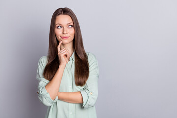 Photo of cute brunette lady ceo finger face look empty space wear blue blouse isolated on grey color background