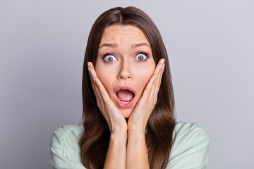 Photo of afraid brunette lady hands head wear blue blouse isolated on grey color background