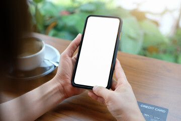 Close up of women's hands holding cell telephone with blank copy space scree for your advertising...