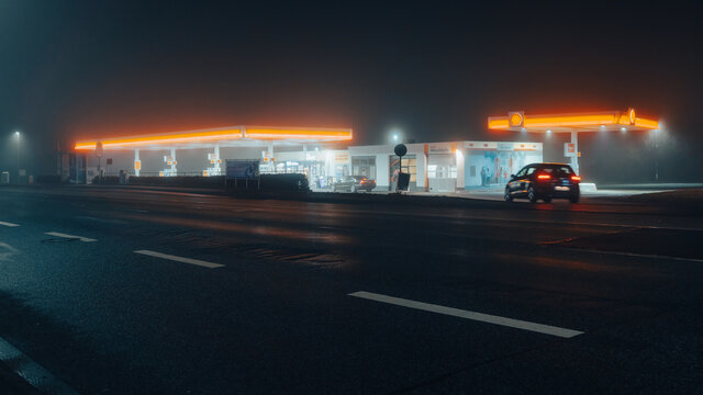 car driving into shell petrol station in foggy night