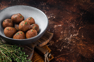 Vegetarian meatless Meatballs from plant based meat with herbs. Dark background. Top view. Copy...