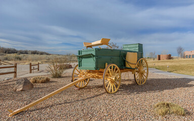 Brightly painted 19th century horse drawn chuck wagon parked on the grounds of a resort in New Mexico