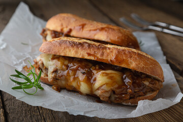 Pulled pork sandwich with melted cheese and BBQ sauce