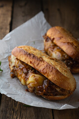 Pulled pork sandwich with melted cheese and BBQ sauce
