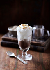 Coffee with whipped cream on dark background. Soft focus. Close up.	