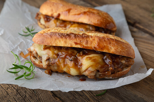 Pulled pork sandwich with melted cheese and BBQ sauce