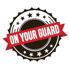 ON YOUR GUARD text on red brown ribbon stamp.