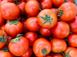 Close-up photo of tomatoes (Beef tomato) in market. Fruit and vegetable background. Texture red tomato. 
