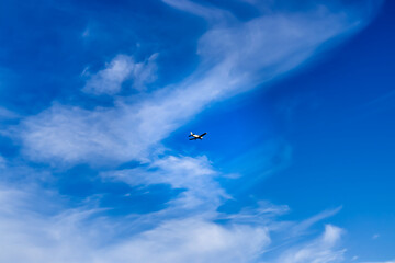 Blue clouds with clouds and a small private plane. Air Transport. Aeroclub. Traveling by air. Hobby flying. Airspace. Means of transport. Between the clouds.