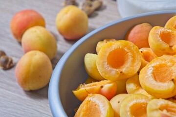Apricot halves in a bowl, preparation for making preserves or jam