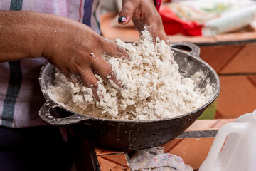 Mujer latina preparando la masa para hacer tortillas de forma artesanal