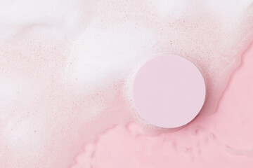 Top view of pink transparent clear calm water surface. Texture with splashes, foam and bubbles with...
