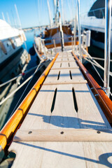 Perspective of a wooden gangway in the harbor of Varazze, Liguria, Italy. Blurred yacths on the...