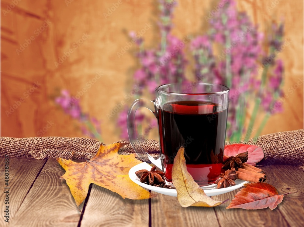 Wall mural hot fruit homemade tea with honey, spices: cinnamon, cardamon, anise, clove. warm autumn drink,