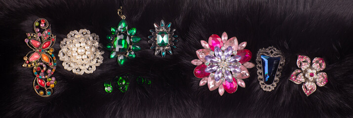 jewelry brooches on a black fur background