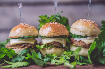 Close up of mini beef burgers isolated on wood background
