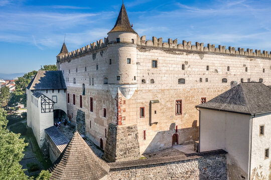 Aerial view of Zvolen Zolyom Gothic - Renaissance castle with inner palace with four turrets outer walls, gate tower blue sky in Slovakia
