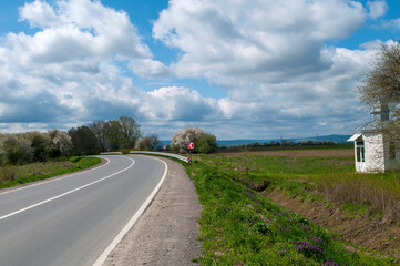 highways in the mountains against the background of the sunny sky and the white clouds