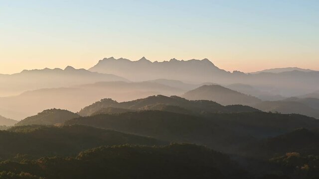 Scenery of Doi Kham Fah viewpoint with sunrise over Doi Luang Chiang Dao mountain with foggy in tropical rainforest at national park