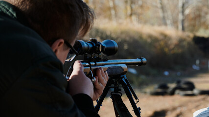 sniper takes aim with a small caliber rifle