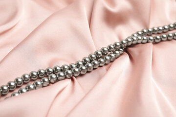 Beautiful silver pearls on delicate pink silk