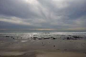 Fototapeta na wymiar The Santa Barbara Pacific ocean beach on a cloudy winter day