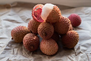 Exotic fruits are piled on top of a peeled fruit. Photographed from the side. Healthy food. Ingredients. For vegetarians.
