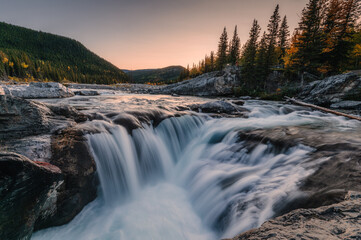 Elbow falls waterfall rapids flowing on rocks in autumn forest at national park