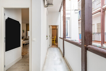 Apartment door and typical Madrid corrala corridor with wooden beams