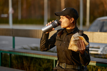 Police woman take break eating in park