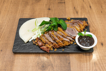 Peking duck with mandarin pancakes. The secret is in the crispy texture of its skin that is achieved with a long roast in the oven.