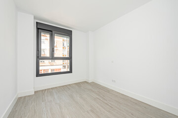 Empty room with black aluminum window with two unequal leaves and ceramic tile floors
